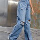 Bella Road Distressed Wide Leg Jeans with pockets, perfect for stylish free spirits. Buttoned design, cotton-polyester blend.