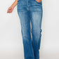 Woman in distressed high rise jeans with pockets, showcasing vintage charm and modern style. Perfect for any outfit.