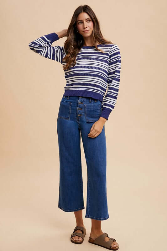 Model showcasing Annie Wear button fly high waist jeans paired with a striped crop sweater for a stylish retro look.