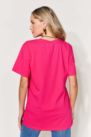 Woman wearing a graphic round neck short sleeve T-shirt in bright pink, back view showing slightly stretchy material