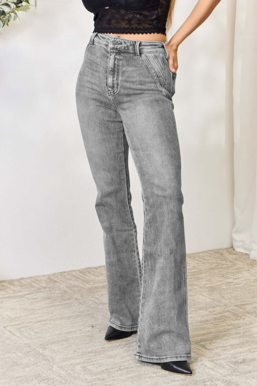 Grey high waist slim flare jeans for women, cinching the waist and elongating the legs with a flattering silhouette. Perfect for stylish versatility.