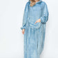 Woman in a cozy blue hooded midi lounge dress with pockets, ready for fall style and comfort.