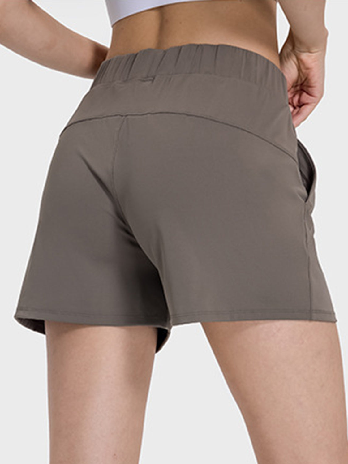 Millennia elastic waist active shorts in a stylish gray, showcasing pockets and a comfortable fit from the back.