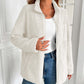 Woman wearing Ivy Lane white fuzzy zip-up jacket with long sleeves and pockets, styled with jeans for a cozy, chic look.