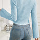 Back view of woman wearing Bella Road Ribbed Drawstring Long Sleeve T-Shirt in blue, paired with denim jeans.