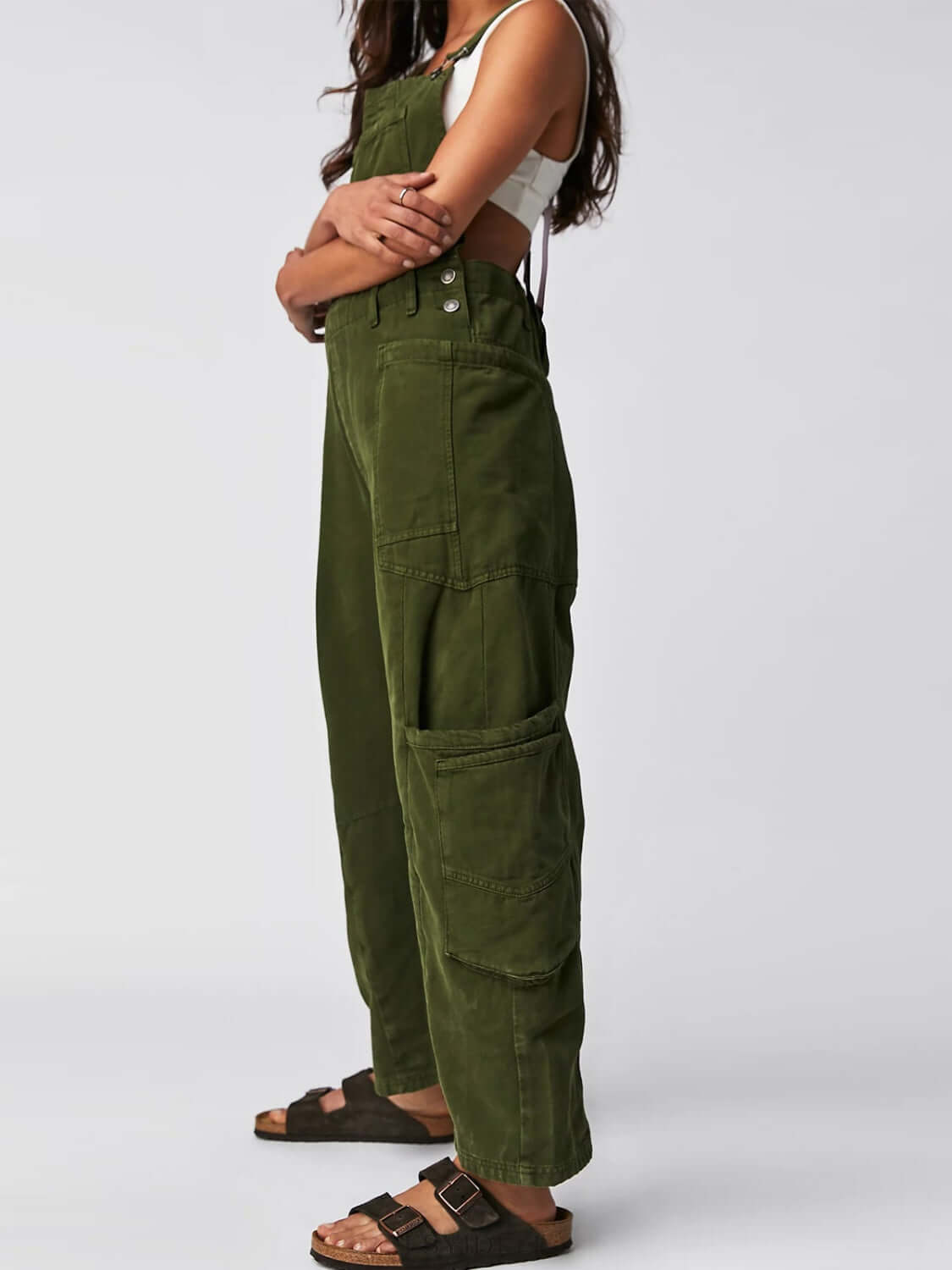 Woman wearing army green Bella Road pocketed wide strap denim overalls, side profile. Fashionable and functional outfit choice.