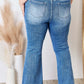 Back view of model wearing High Rise Ankle Flare Risen Jeans, showcasing flattering fit and quality stitching.