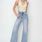 Trendy high rise crop wide fray hem jeans with flattering silhouette and edgy style, paired with a chic top and heels.