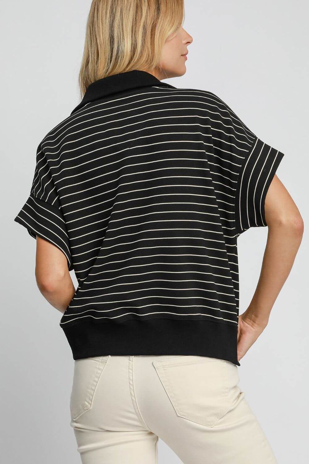 Stylish Umgee striped half zip short sleeve sweatshirt in black and white, perfect for casual spring and summer wear.