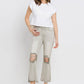 Woman wearing Lovervet distressed raw hem cropped flare jeans with a white t-shirt and high heels.