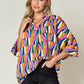 DOUBLE TAKE Full Size Geometric Notched Raglan Sleeve Blouse at Bella Road