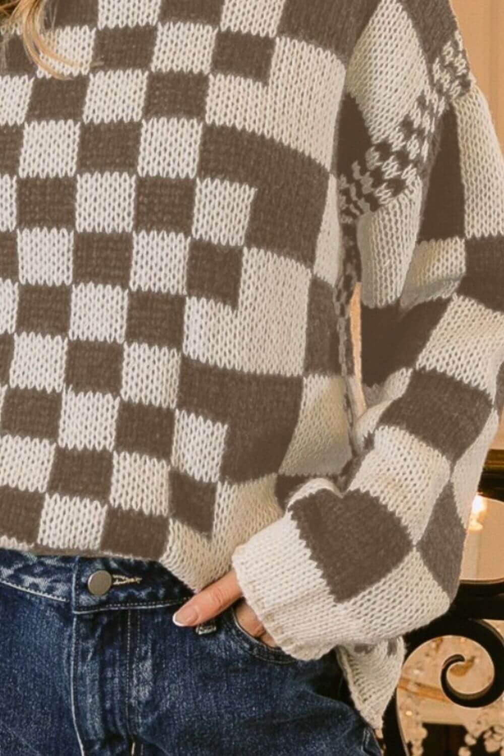 Woman wearing BiBi Checkered Contrast Chunky Sweater with bold checkered design and jeans