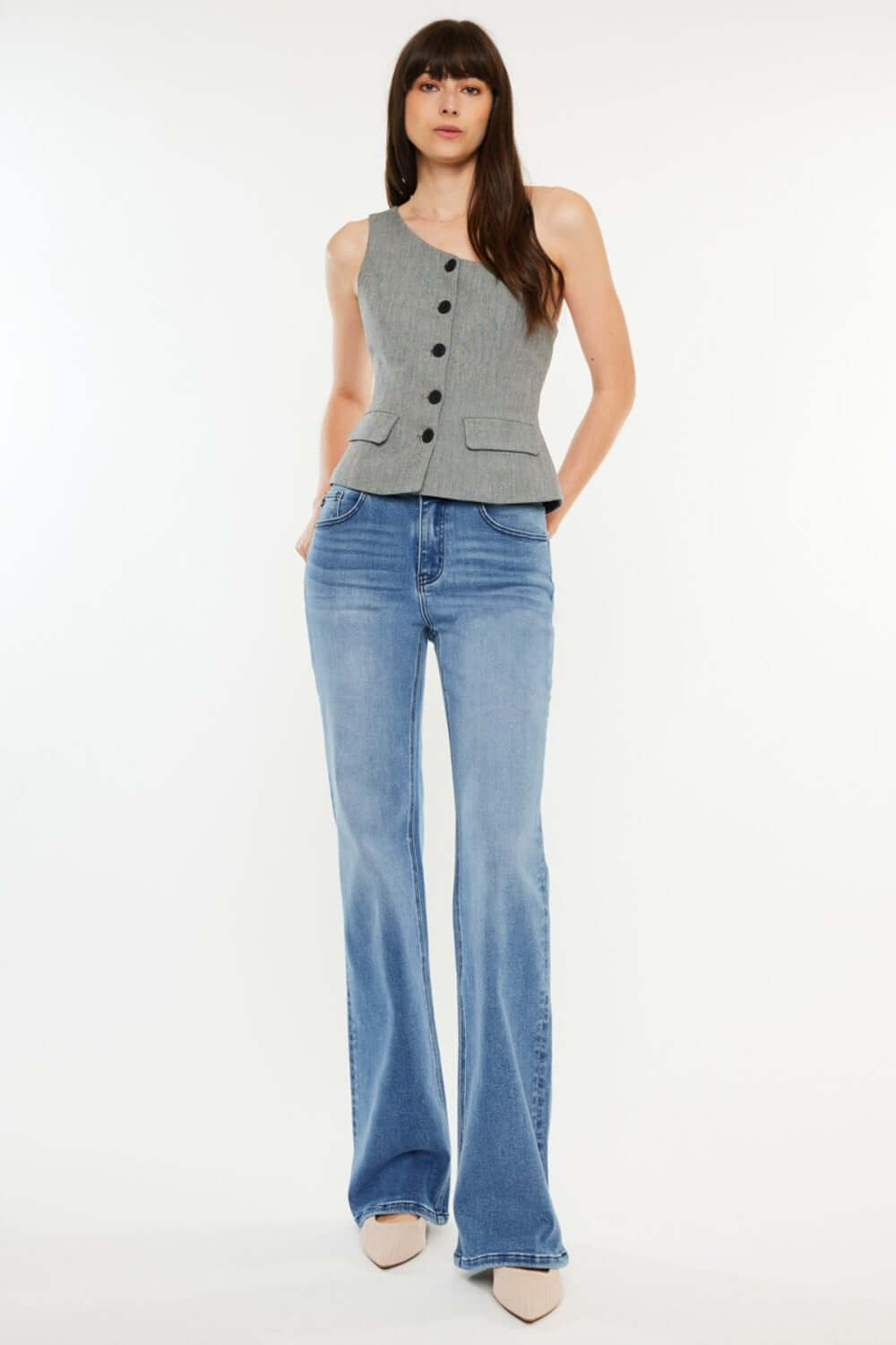 Woman modelling Ultra High Rise Cat's Whiskers Jeans with vintage detailing and a grey buttoned top, showcasing a chic high-waisted silhouette.