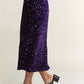 Elegant purple sequin midi skirt with back slit, perfect for glamorous nights out and special occasions.