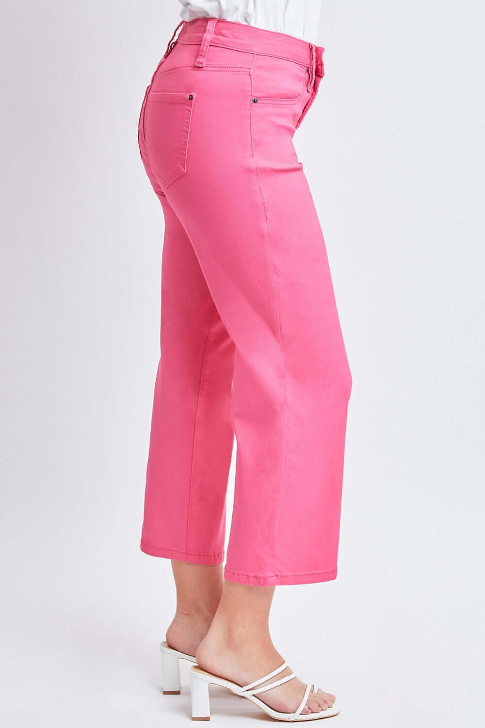 Woman wearing hot pink Mid-Rise Hyperstretch Cropped Straight Pants by YMI Jeans with white sandals