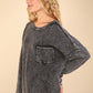 Woman wearing a VERY J Mineral Washed Exposed Seam Sweater with drop shoulder and patch pocket, showcasing its relaxed fit and vintage fabric.