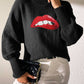 Black Bella Road Lip Turtleneck Sweater with bold red lip design, worn with white pants and black clutch for stylish look