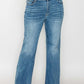 Model wearing bytos Cat's Whiskers Mid Rise Bootcut Jeans in light wash, showcasing flattering fit and stylish design.