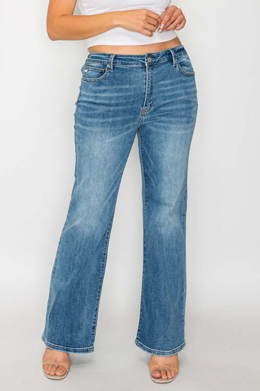 Model wearing bytos Cat's Whiskers Mid Rise Bootcut Jeans in light wash, showcasing flattering fit and stylish design.