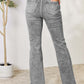 High Waist Slim Flare Jeans in grey, featuring back pockets, shown on model standing with hands in pockets, styled with a black lace top.