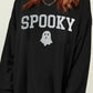 Woman wearing Bella Road SPOOKY round neck long sleeve sweatshirt with ghost design, perfect for cozy and spooky occasions.