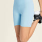 Light blue Millennia Seamless High-Rise Biker Shorts with wide waistband and flexible fit for ultimate comfort.