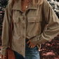 Woman wearing textured pocketed collared neck long sleeve shacket with blue jeans, outdoors.