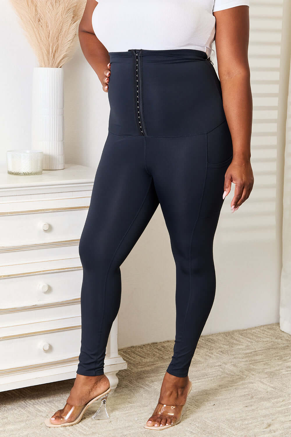 Heimish Full Size Waist Trainer Corset Leggings in black providing sleek, hourglass silhouette and secure fit for intense workouts.