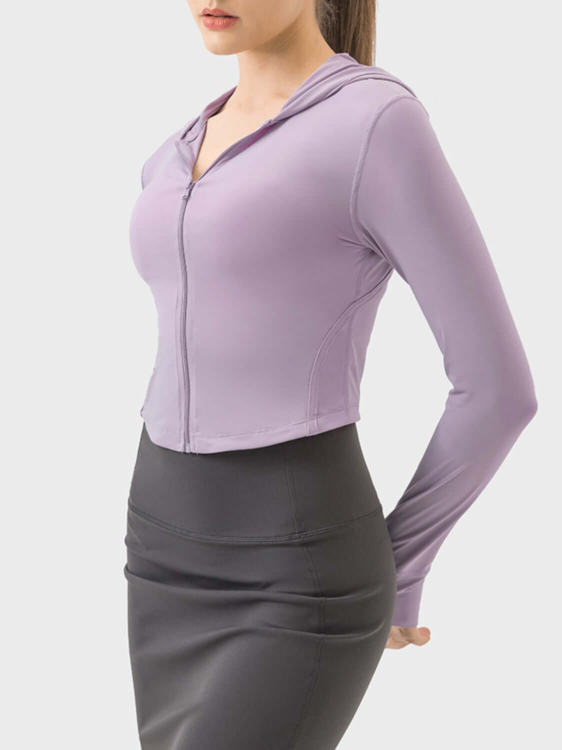 Woman in a stylish purple zip-up hooded active outerwear, perfect for workouts and casual wear.