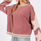 Woman wearing SAGE + FIG French Terry Star Applique Patch Sweatshirt, casual chic style, cozy pink top with star detailing.