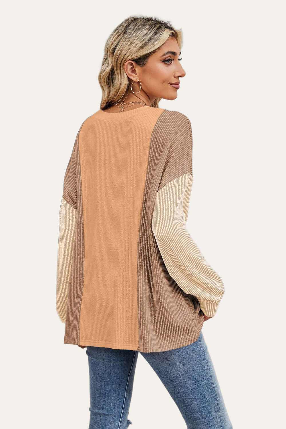 Woman wearing Double Take Texture Contrast Round Neck Long Sleeve T-Shirt in trendy color combo, ideal for stylish layering.