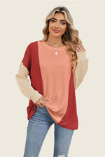 Woman wearing Double Take Texture Contrast Round Neck Long Sleeve T-Shirt in red and beige, perfect for layering or a standout look.