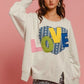 Cozy BiBi LOVE Heart Patch Slit French Terry Sweatshirt with colorful LOVE design, perfect for casual outfits.