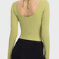 Back view of Millennia Halter Neck Long Sleeve Sporty Top in olive green, showcasing stylish tied halter design.