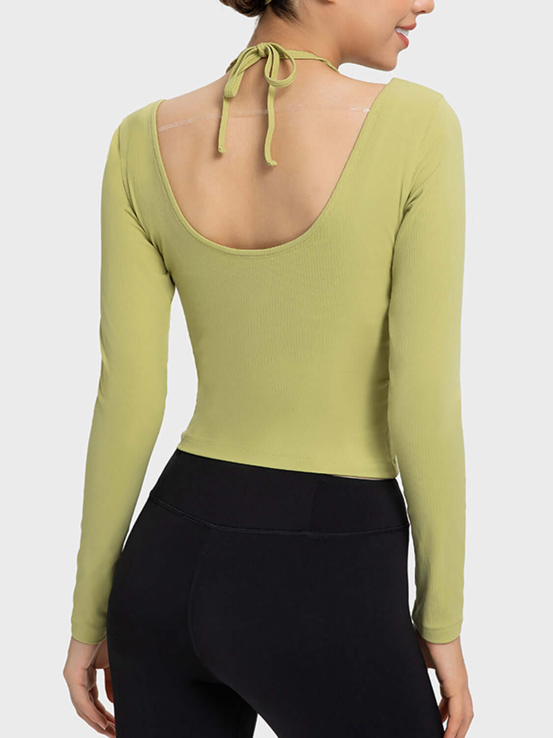 Back view of Millennia Halter Neck Long Sleeve Sporty Top in olive green, showcasing stylish tied halter design.