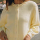 Woman wearing a cozy pastel yellow button-down long sleeve cardigan by Bella Road, perfect for chilly days.