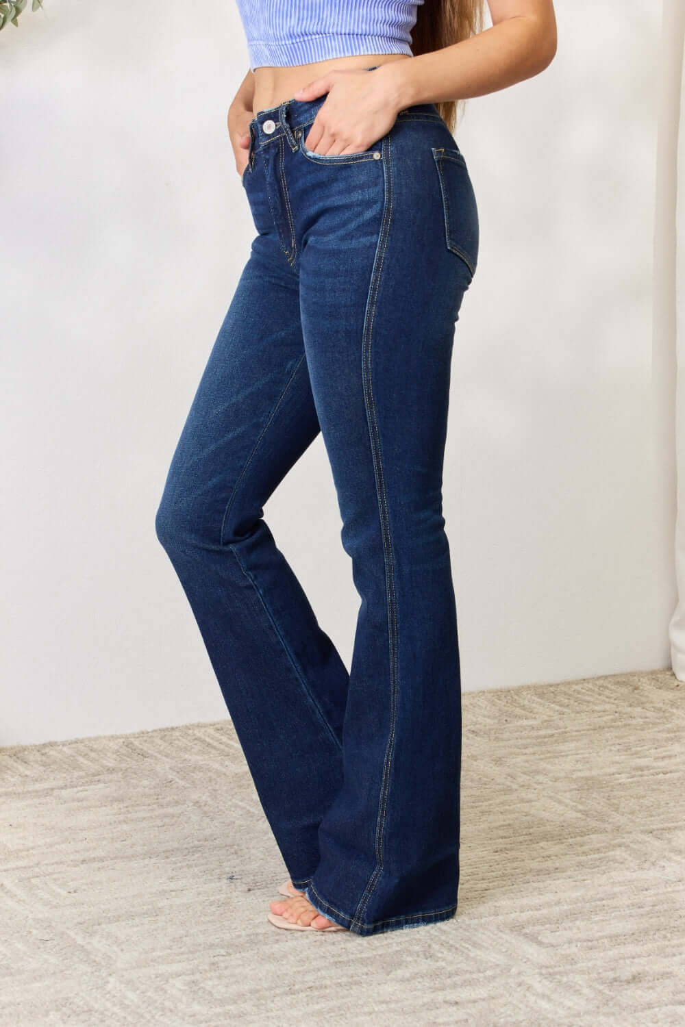 Woman wearing Slim Bootcut Jeans that hug curves with a flattering bootcut leg, perfect for dressing up with heels or casual with sneakers.