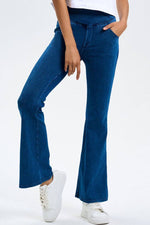 Model showcasing Basic Bae Pocketed Highly Stretchy Bootcut Jeans in classic blue, highlighting their comfy fit and stylish pockets.