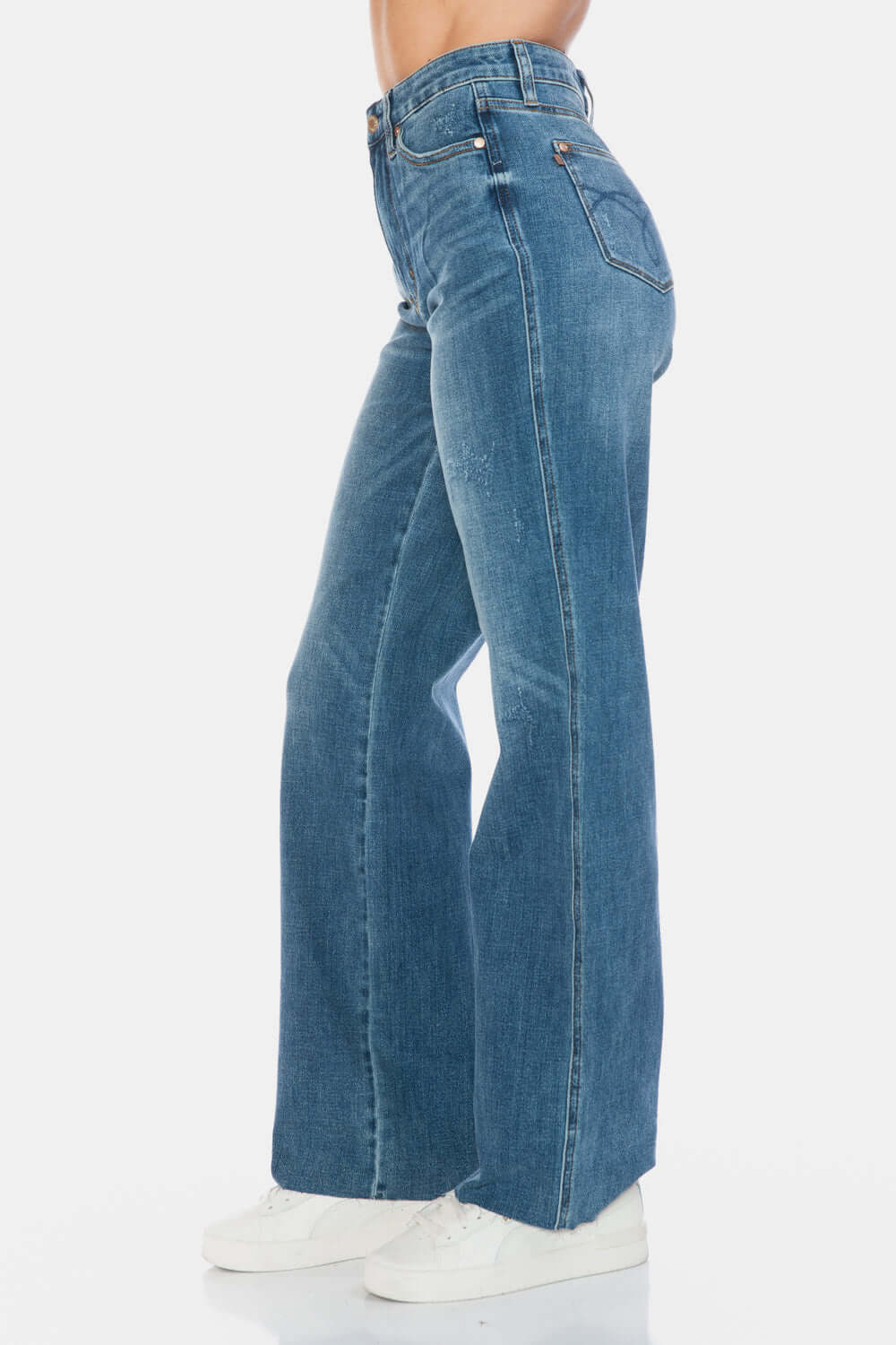 Judy Blue high-waist tummy control jeans with raw hem, showcasing flattering straight leg fit and trendy style.