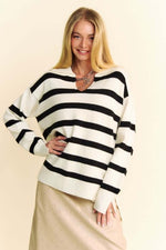 Woman modeling Davi & Dani high-low striped sweater with Johnny collar, featuring side slits and a chic casual look.