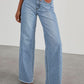 Woman wearing Bella Road raw hem wide leg jeans with pockets, featuring a high waist and light blue denim.