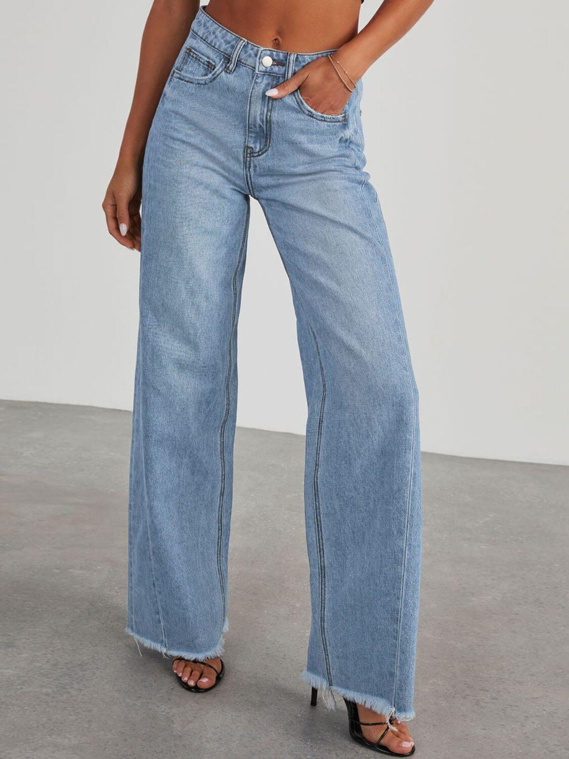 Woman wearing Bella Road raw hem wide leg jeans with pockets, featuring a high waist and light blue denim.