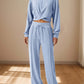 Woman wearing Bella Road Crisscross Round Neck Top and Drawstring Pants Set in light blue.