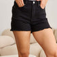 Woman wearing RFM Jeans tummy control high waist black denim shorts with frayed hems.