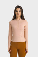 Millennia Half Zip Thumbhole Sleeve Sports Top in soft pink, perfect for yoga and workouts, featuring comfort and style.