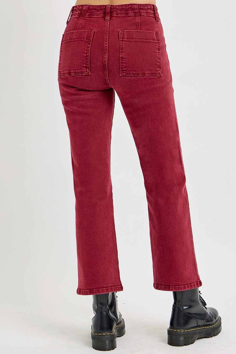 High rise straight jeans with patch pockets in deep red, showcasing a classic yet modern look with black boots.