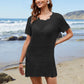 Model in a stylish black openwork cover-up at the beach, showcasing a round neck and short sleeves. Perfect for summer!