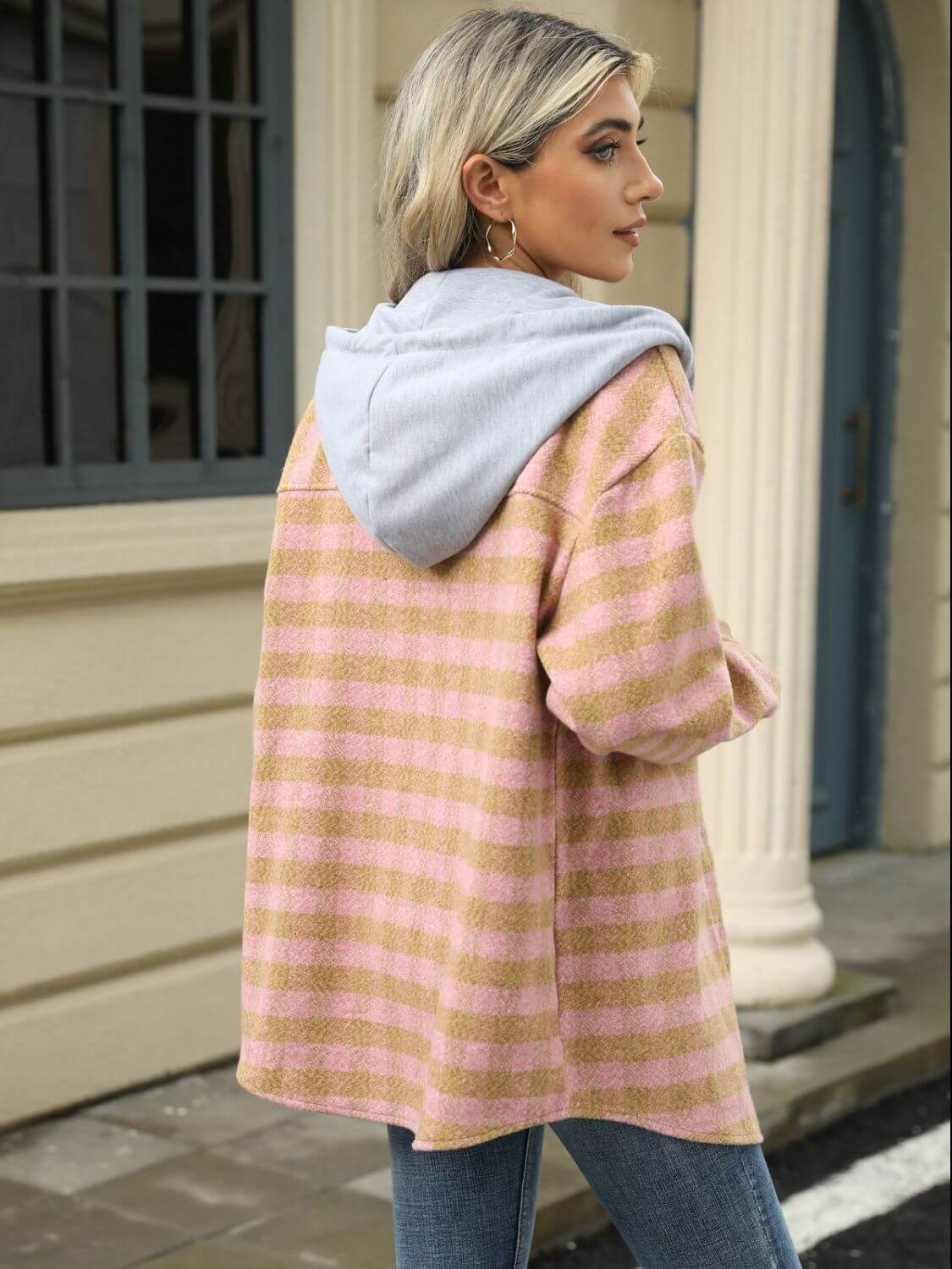 Woman wearing Bella Road Drawstring Plaid Long Sleeve Hooded Jacket in pink and gray, standing outdoors