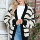 Woman wearing Bella Road Striped Contrast Open Front Long Sleeve Cardigan with stylish black and white design.