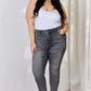 Woman wearing High Waist Tummy Control Release Hem Skinny Jeans in gray by Judy Blue, showcasing flattering silhouette and chic release hem detail